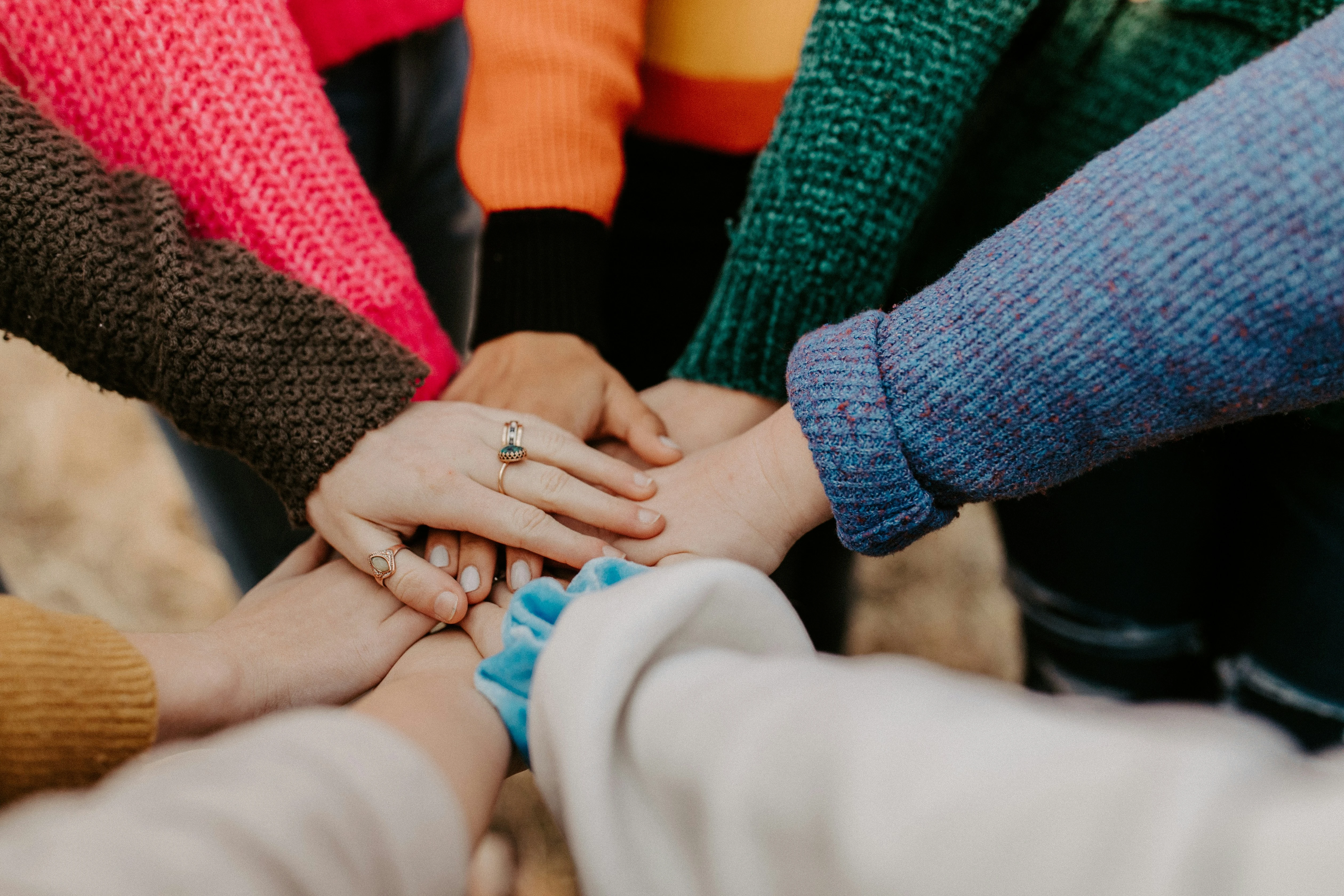 Hands in the middle of a huddle.